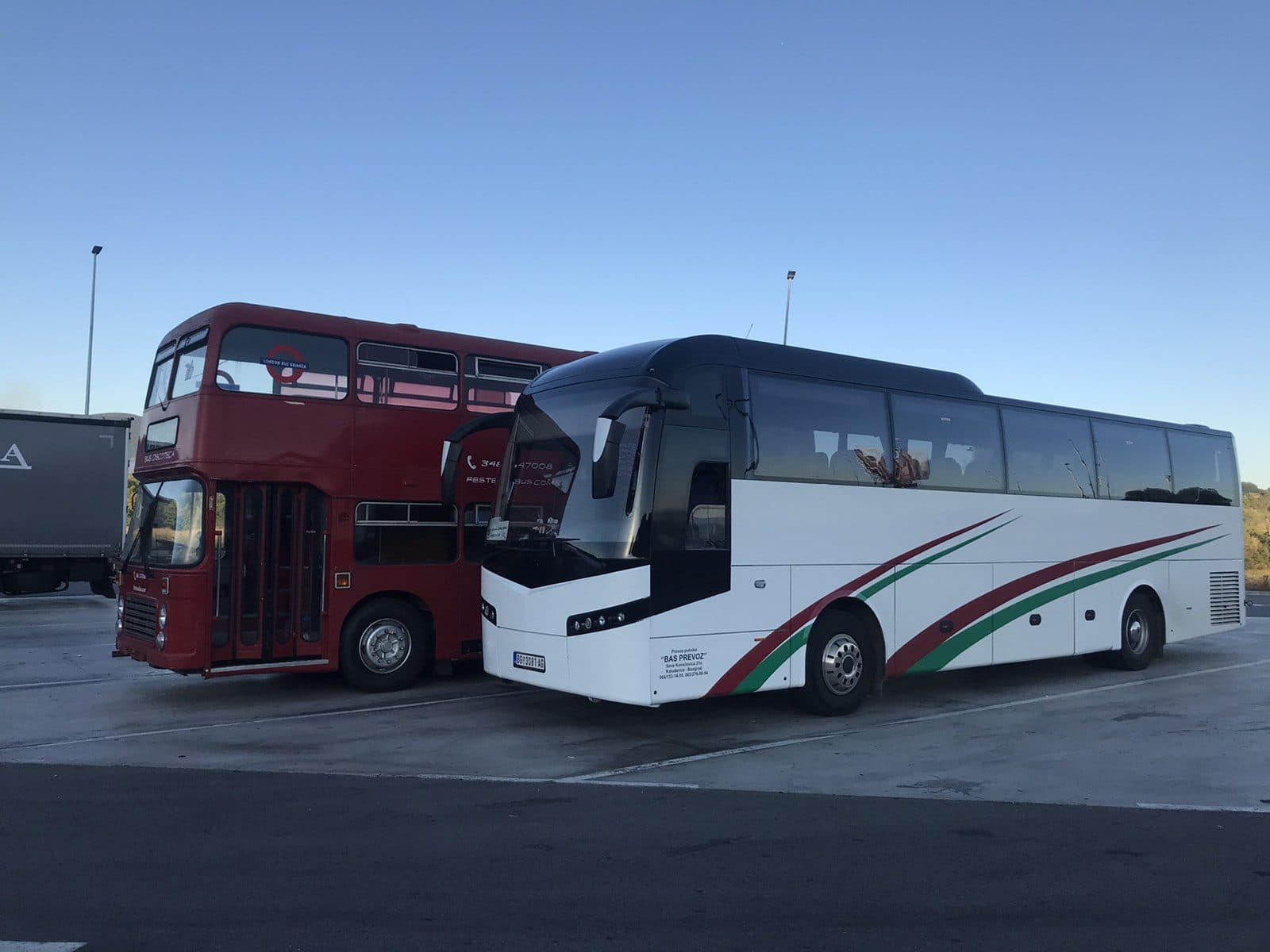 White BAS PREVOZ coach beside a red double-decker
