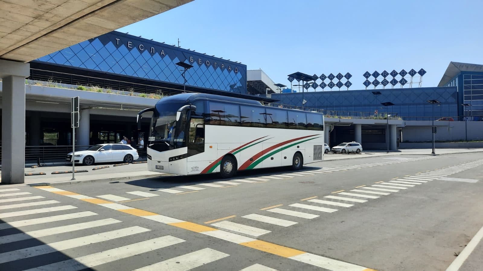Coach beside a modern building
