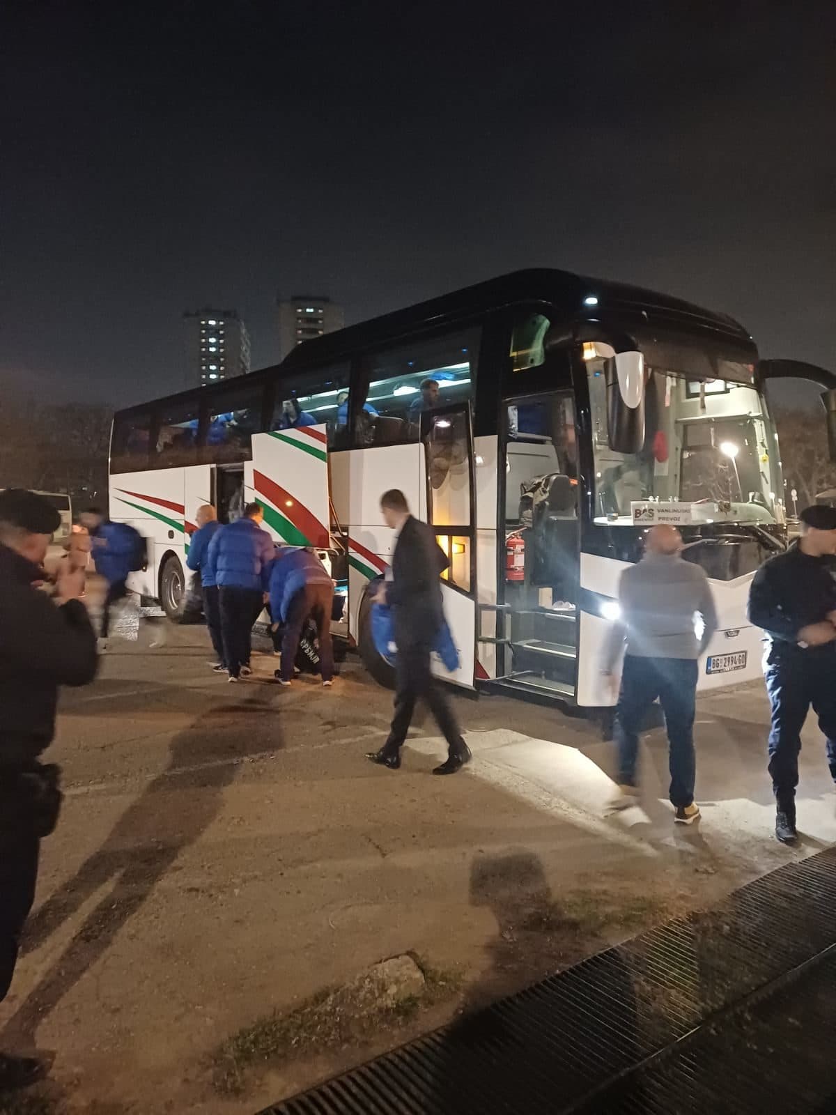 Passengers boarding the coach at night