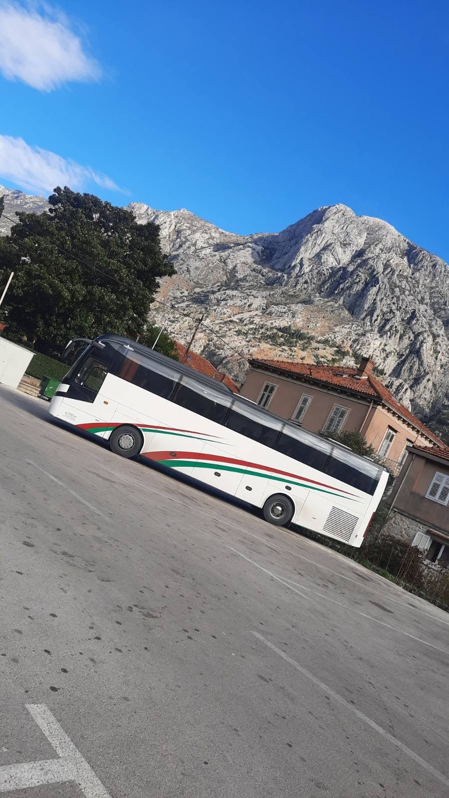 Coach below a mountain