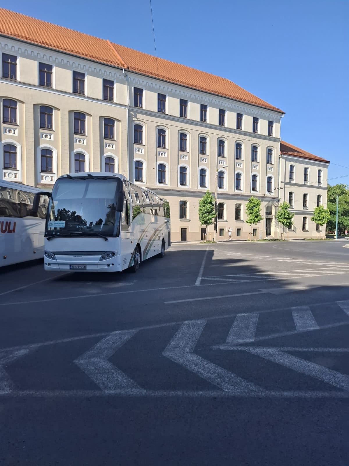 Coach in front of a building on a town square