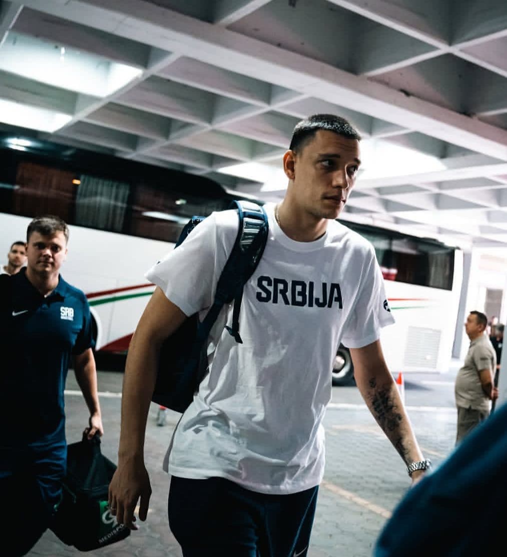 Serbian national team player with a backpack in front of the coach