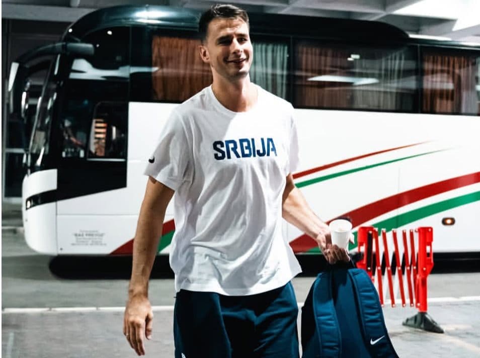 Serbian national team player with a coffee beside the coach