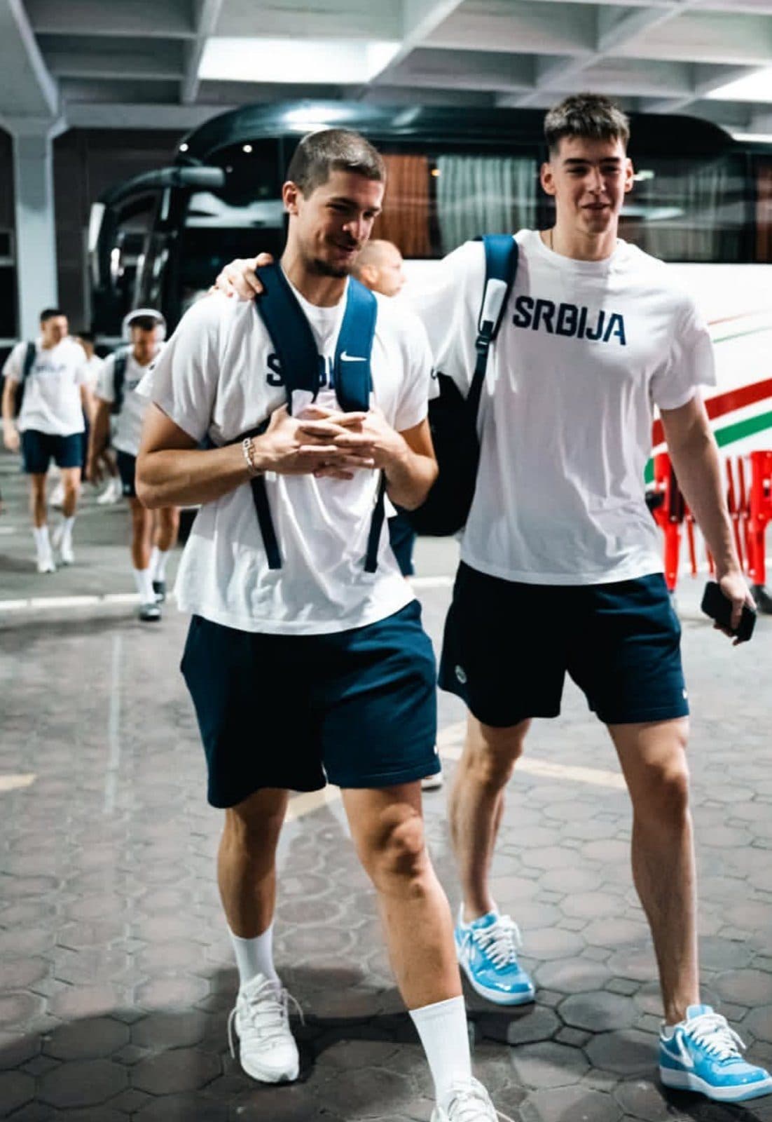 Two Serbian national team players leaving the coach
