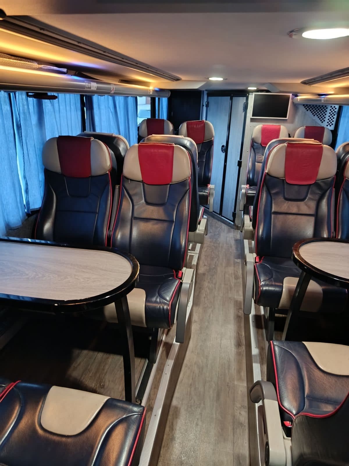 Lounge with leather seats and a table in the VIP coach