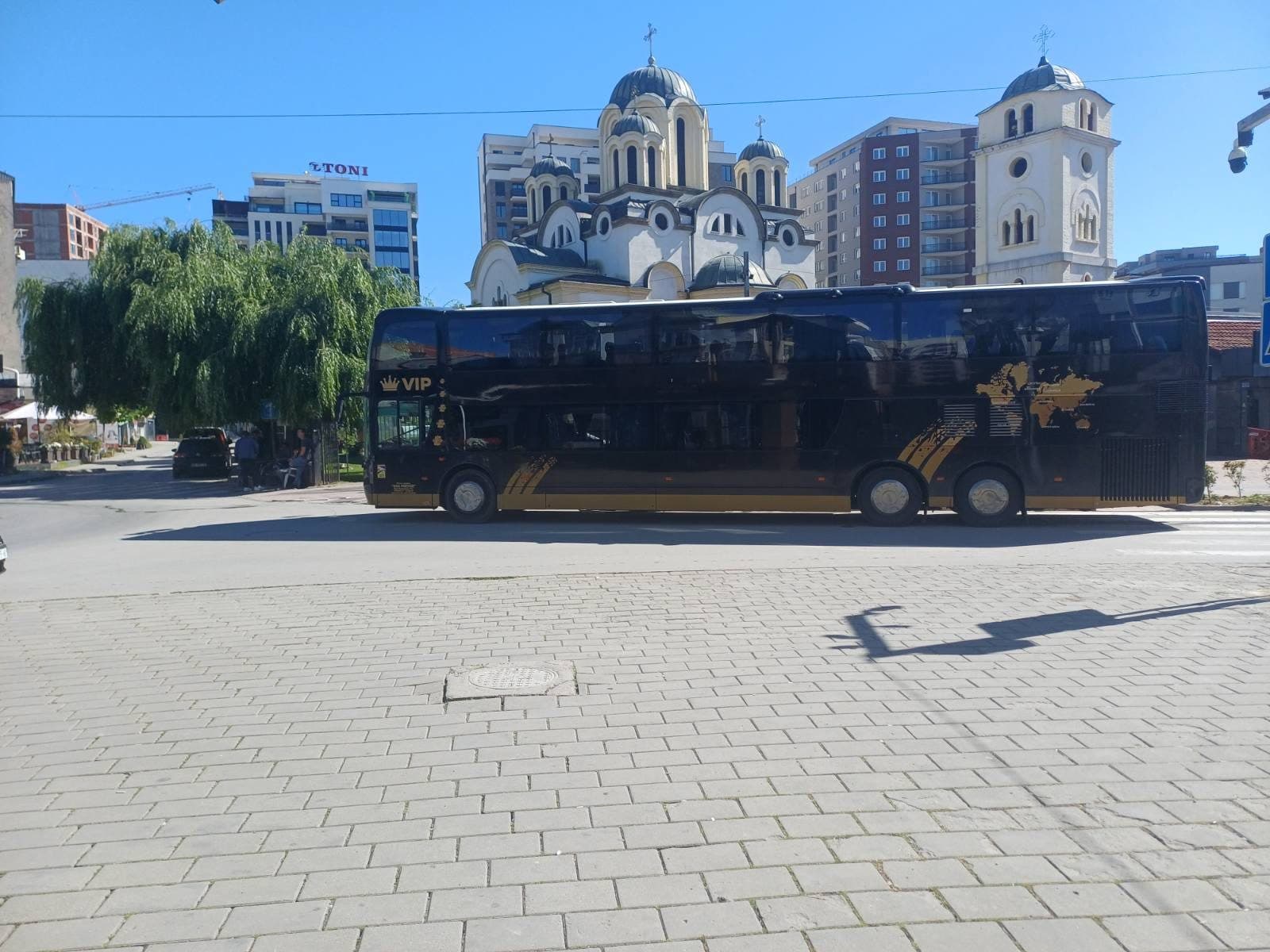 VDL Synergy VIP in front of a town church