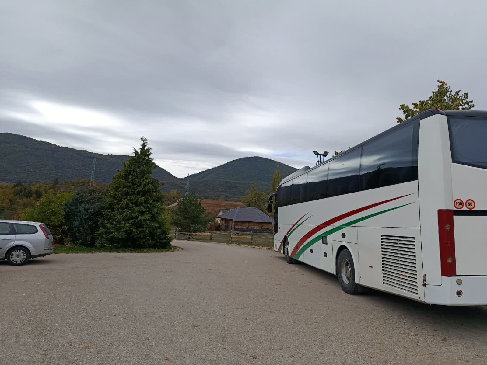 White coach in a mountain car park